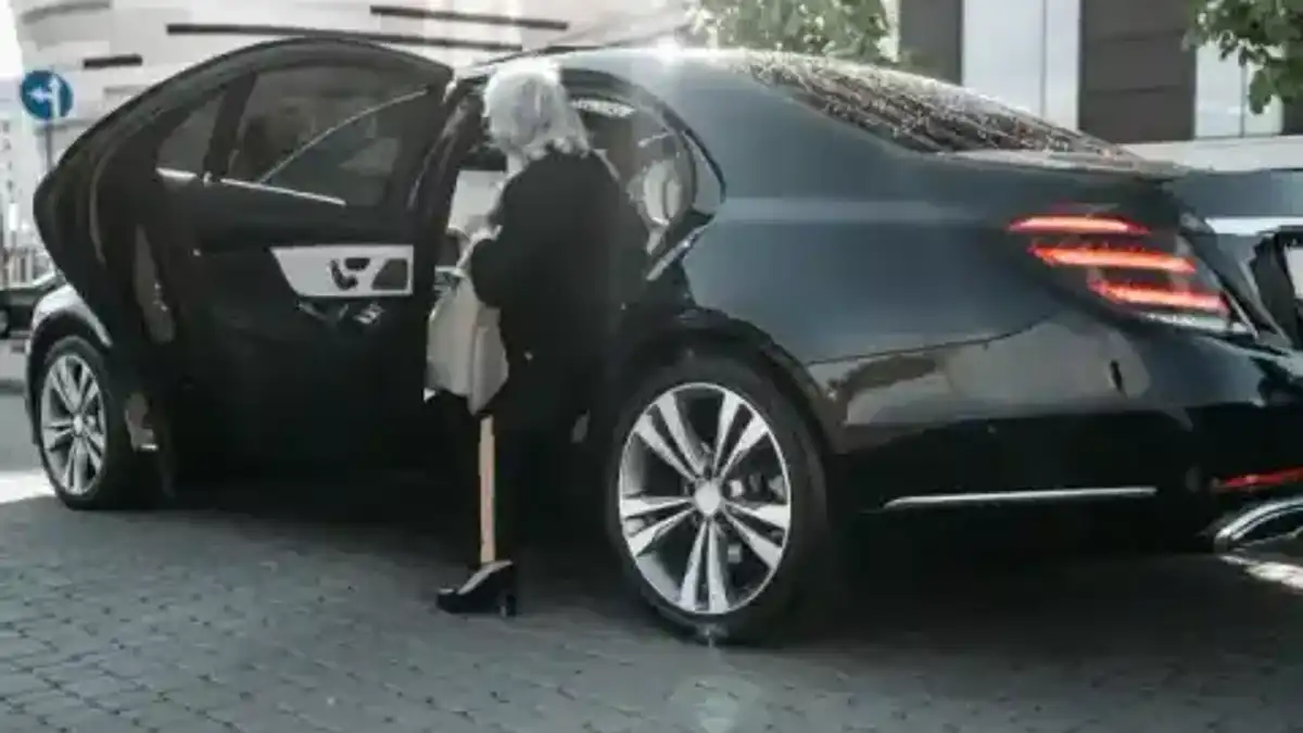 Passagère embarquant dans une berline avec chauffeur — sélection Holiday Extras Transfers